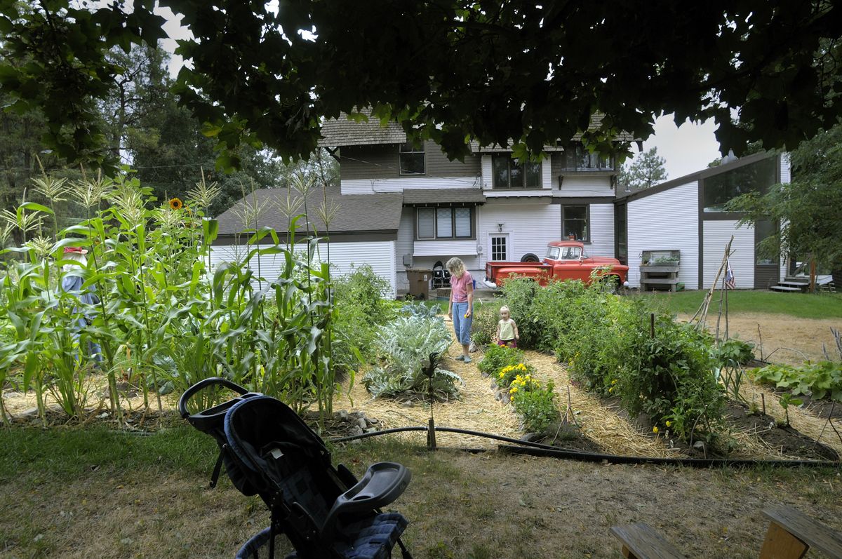 Wanda Daehlin walks with her granddaughter Elie Daehlin through the community garden in the 1500 block of South Ash last month.   (CHRISTOPHER ANDERSON / The Spokesman-Review)