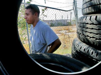 
Jose Perez stands at the tire shop where he works. Perez gave water to a homeless woman before she died of heat exposure. 
 (Associated Press / The Spokesman-Review)