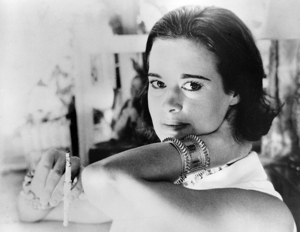 In this Jan. 4, 1964 photo, railroad heiress Gloria Vanderbilt poses for a photograph. Vanderbilt, the intrepid heiress, artist and romantic who began her extraordinary life as the "poor little rich girl" of the Great Depression, survived family tragedy and multiple marriages and reigned during the 1970s and 