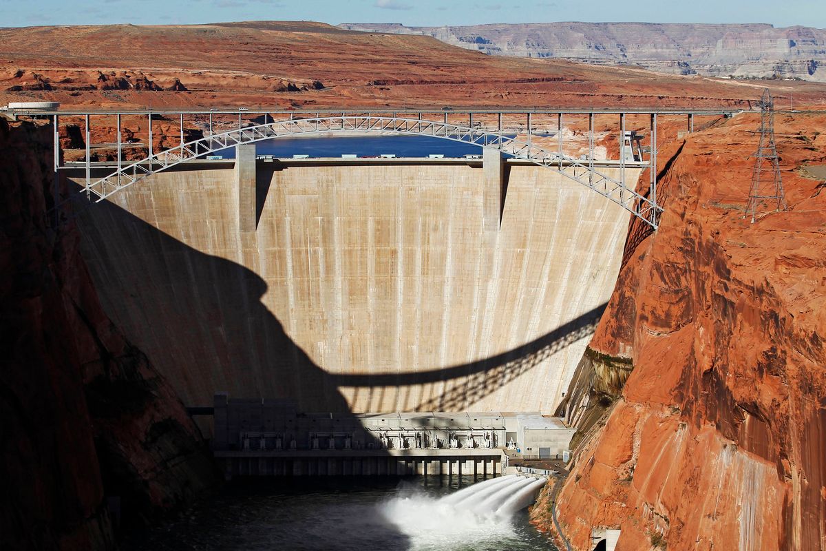 FILE - In this Nov. 19, 2012, file photo, water is released into the Colorado River at the Glen Canyon Dam in Page, Ariz. The elevation of Lake Powell fell below 3,525 feet (1,075 meters), a record low that surpasses a critical threshold at which officials have long warned signals their ability to general hydropower is in jeopardy. (Rob Schumacher)