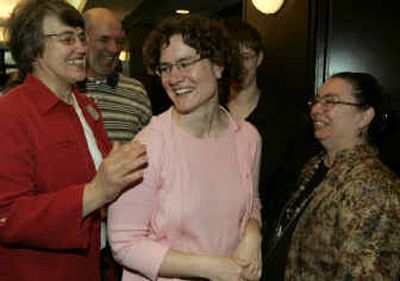 
Defrocked associate pastor Irene Elizabeth Stroud, center, reacts as she is congratulated by her mother Jamie Stroud, right, and her partner's mother Carol Paige, left, after winning her appeal. 
 (Associated Press / The Spokesman-Review)