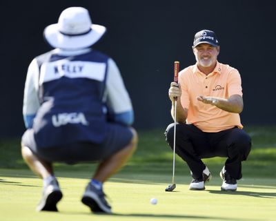 Jerry Kelly confers with his caddie, Eric Meller, on a putt on the 13th green during the first round of the U.S. Senior Open golf tournament Thursday, June 28, 2018, in Colorado Springs, Colo. (Jerilee Bennett / Gazette via AP)