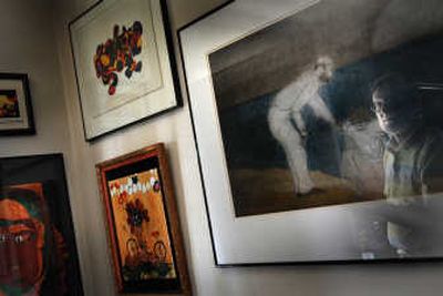 Zeke Crapo, seen reflected in the glass, has been producing art for decades and has dabbled in all sorts of styles from line art to modern painting.
(Rajah Bose / The Spokesman-Review)