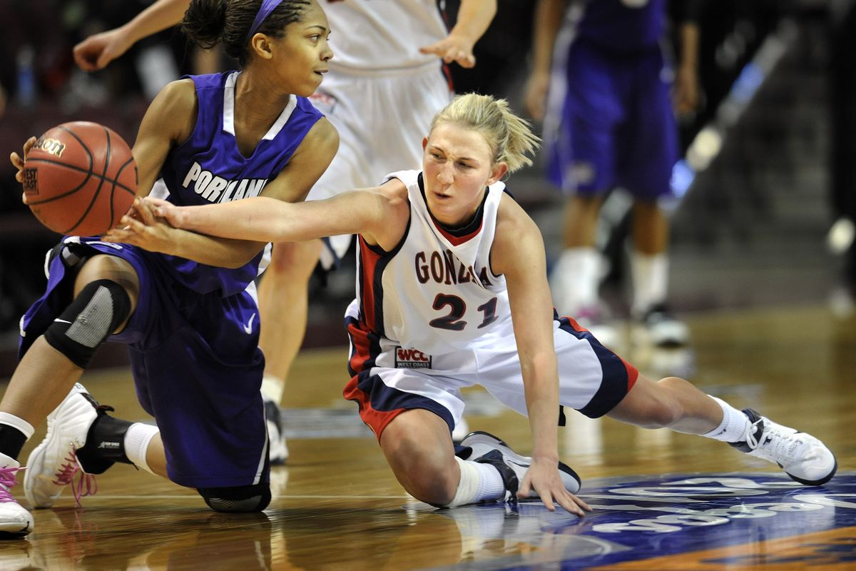 Courtney Vandersloot of Gonzaga dives in to try and knock the ball loose from  Alexis Byrd of Portland  in their semifinal game of the WCC Tournament in Las Vegas on Sunday, March 6, 2011.  The Zags won the game to advance to the Monday final. (Christopher Anderson / The Spokesman-Review)