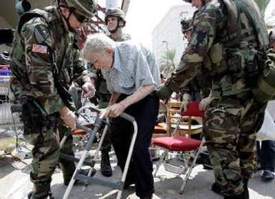 
Lt. Col. John Edwards and other members of the National Guard help Clifton Oxley, 83, on Friday during the evacuation at the convention center in New Orleans.
 (Associated Press / The Spokesman-Review)
