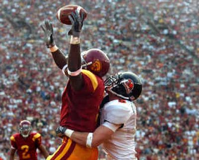 
Mike Williams made this TD grab against Oregon State's Mitch Meeuwsen while playing for USC in December 2003. 
 (File/Associated Press / The Spokesman-Review)