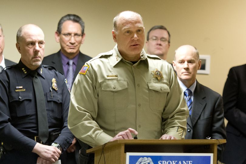 Spokane County Sheriff Ozzie Knezovich, center, talks to reporters, along with police Chief Frank Straub, left, and interim Special Agent in Charge W. Jay Abbott, right. (Jesse Tinsley)