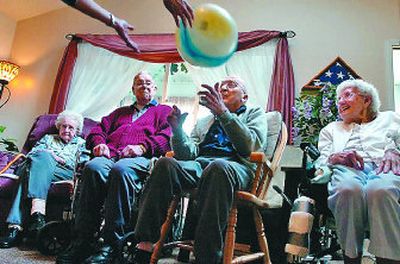 
Alice Thibault, not seen, uses a plastic ball as an exercise game with residents, from left, Lily Foster, Ed Ruhnke, Frank Bissell and Mary Cook. 
 (Photo by JESSE TINSLEY / The Spokesman-Review)