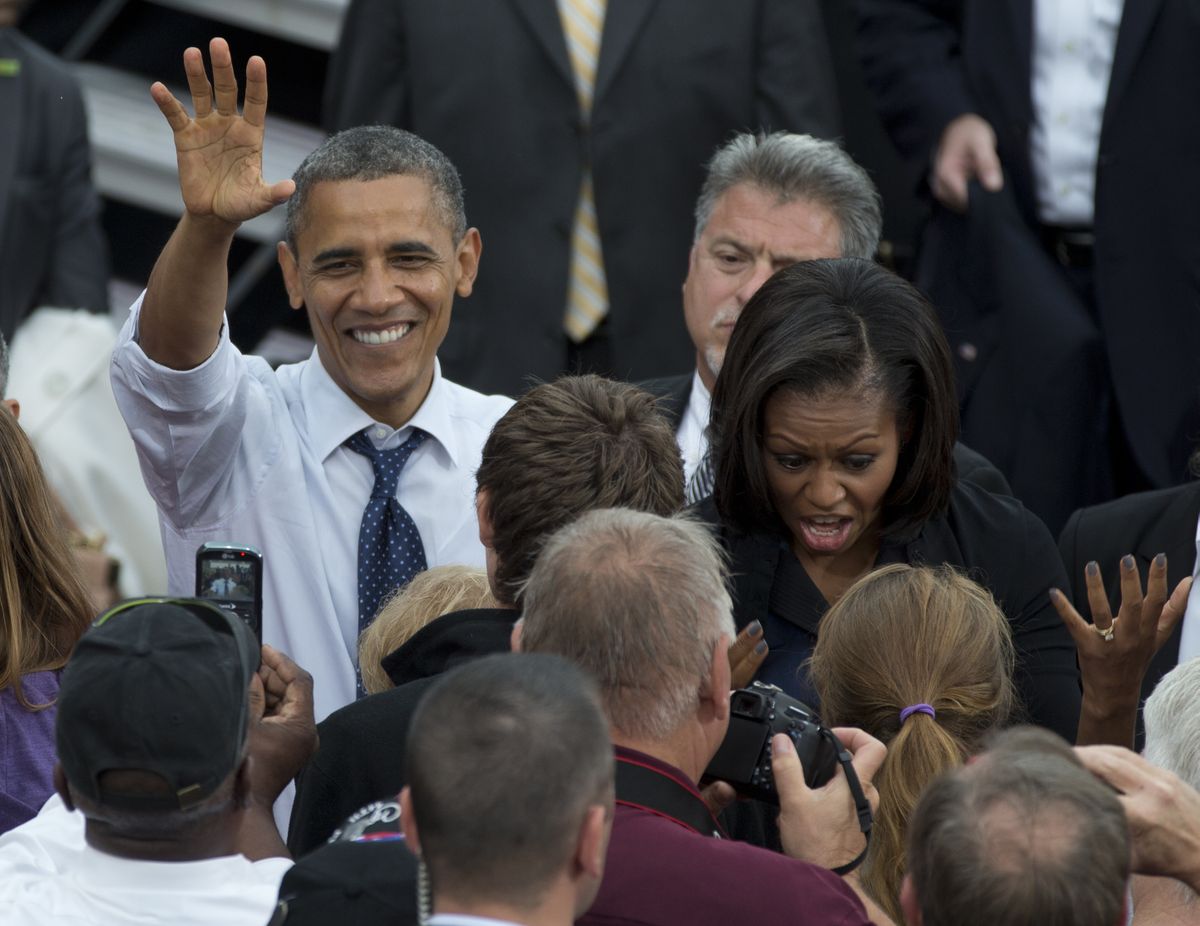 President Barack Obama and first lady Michelle Obama greet people in the crowd during a campaign event at University of Iowa, Friday, Sept. 7, 2012, in Iowa City, Iowa. (Carolyn Kaster / Associated Press)