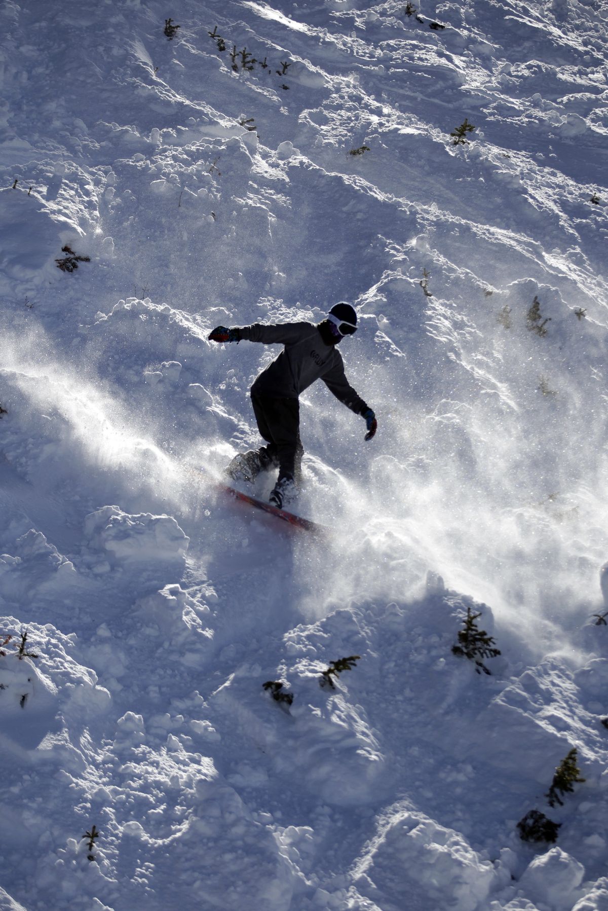 A snowboarder goes down a slope at the Brighton Ski Resort along the Wasatch Range.