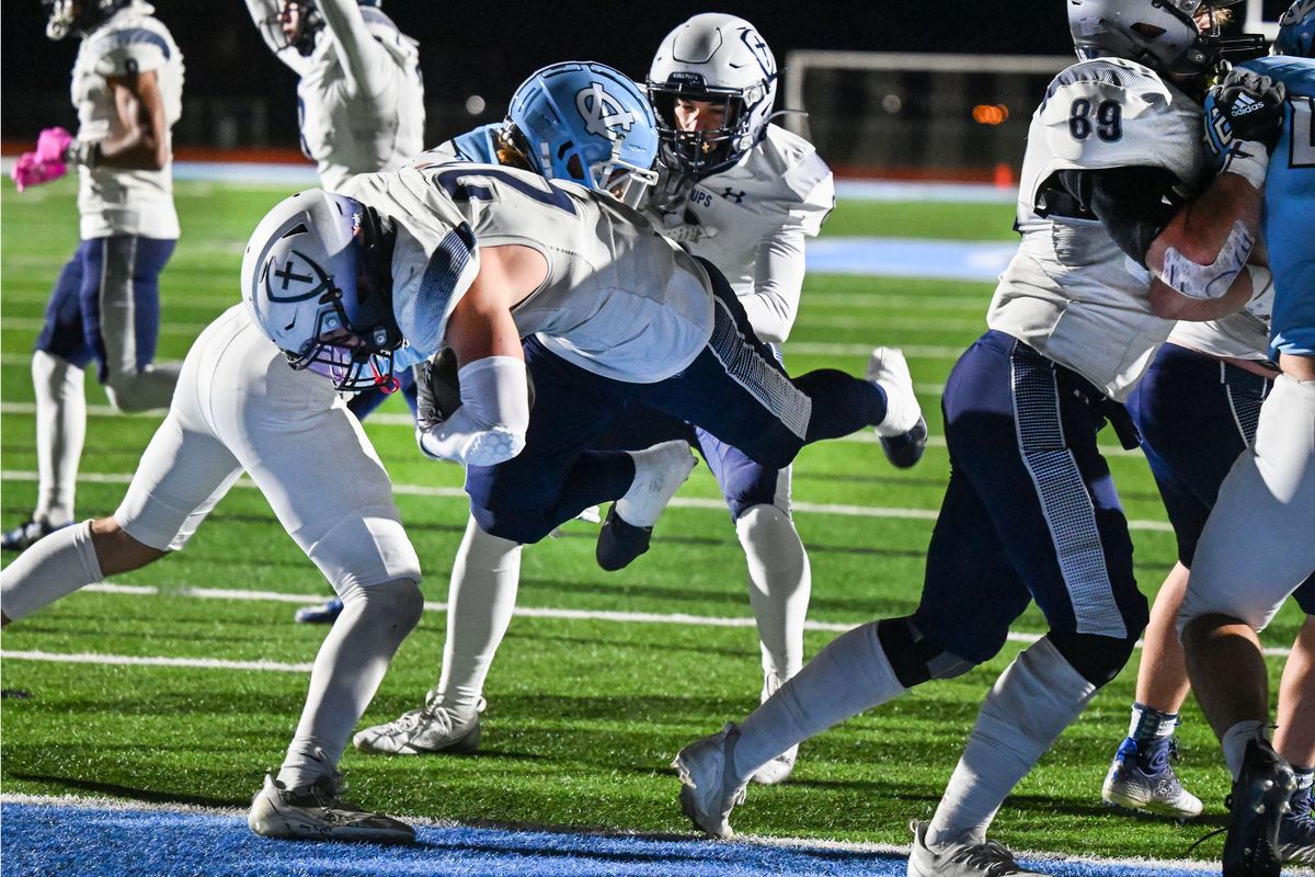 Gonzaga Prep running back Noah Holman (21) dives into the end zone for a touchdown against Central Valley during the first half of a high school football game, Friday, Oct. 18, 2024, at Central Valley.  (Colin Mulvany/The Spokesman-Review)