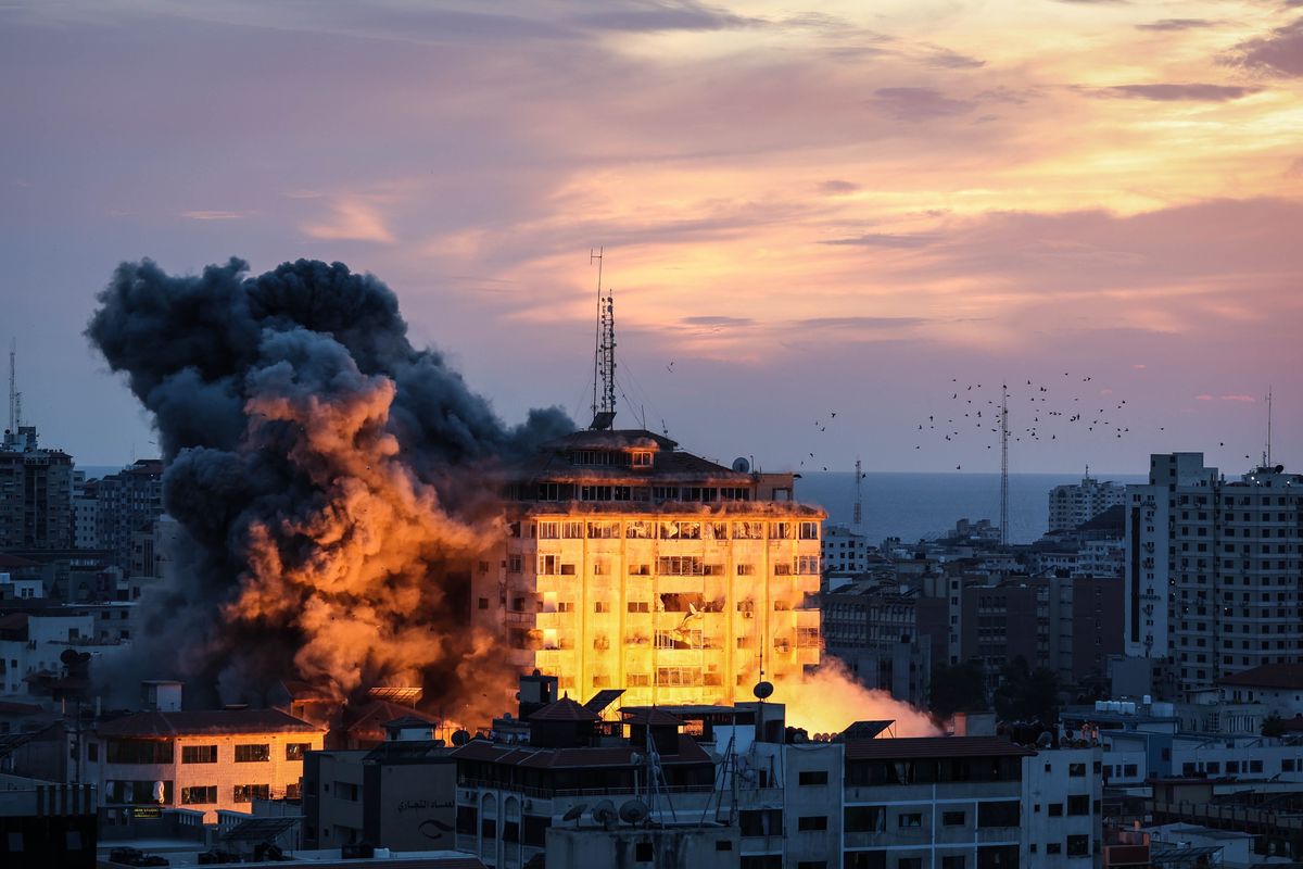 An Israeli strike destroys the Palestine Tower in the Rimal neighborhood in the central Gaza Strip on Saturday.  (Loay Ayyoub/For The Washington Post)
