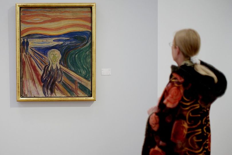 A visitor looks at Edvard Munch's painting 
