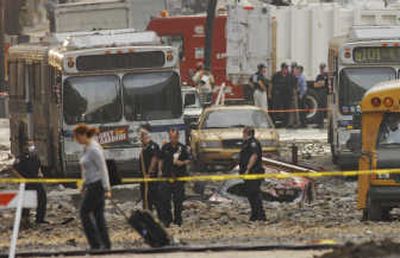 
Emergency workers pore over the site of a steam pipe explosion in midtown Manhattan on Thursday. The pipe exploded Wednesday underneath a street near Grand Central Terminal. Associated Press
 (Associated Press / The Spokesman-Review)