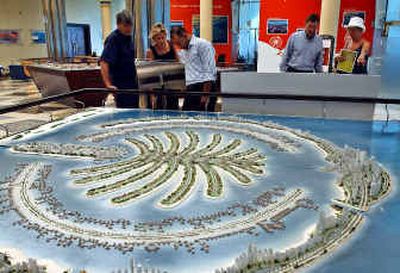 
Customers look at the model of Jebel Ali Palm Island at the Nakheel sales center in Dubai, United Arab Emirates. The project will set a new precedent for manmade construction.
 (Associated Press / The Spokesman-Review)