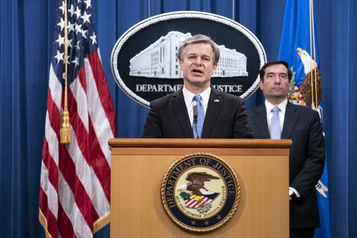 FBI Director Christopher Wray speaks during a virtual news conference at the Department of Justice, Wednesday, Oct. 28, 2020 in Washington, as Assistant Attorney General for National Security John Demers looks on. The Justice Department has charged eight people with working on behalf of the Chinese government to locate Chinese dissidents and political opponents living in the U.S. and coerce them into returning to China. Five of the eight were arrested Wednesday morning.  (Sarah Silbiger)