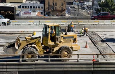 
Road crews work at repairing the roadbed of the eastbound lanes of the I-90 overpass in downtown Spokane.
 (Colin Mulvany / The Spokesman-Review)