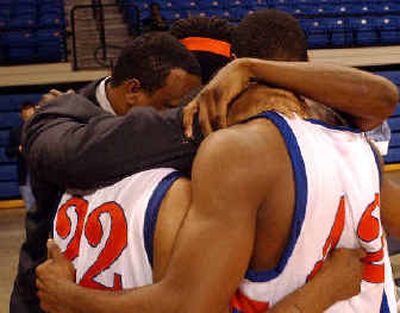 
Athletic director Tony O'Neal and some players share a postgame prayer. 
 (Associated Press / The Spokesman-Review)