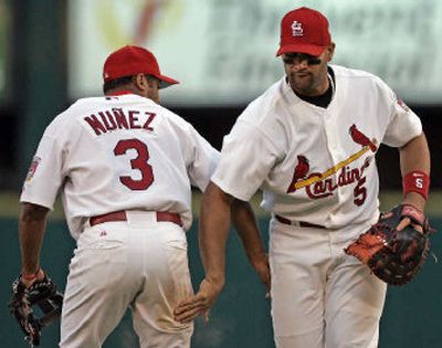 
Cardinals have winning down pat as Abraham Nunez and Albert Pujols congratulate each other after their Game 2 victory. 
 (Associated Press / The Spokesman-Review)