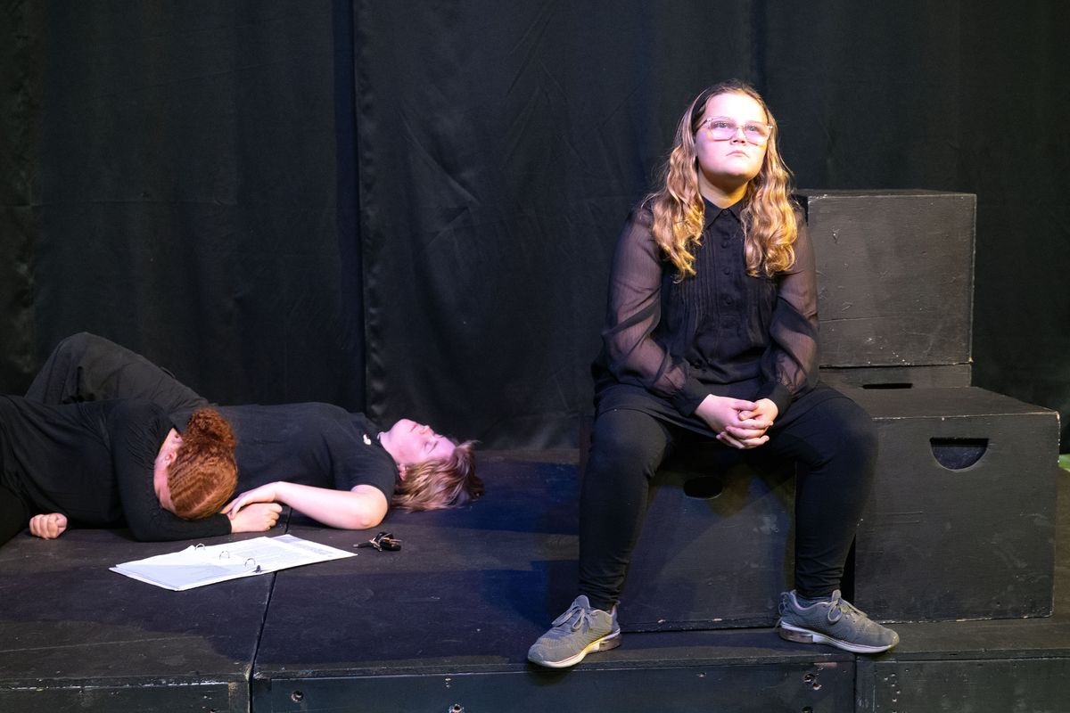 Madi Brownlee, 14, playing a handgun, contemplates its actions after shooting a couple, played by Elise Gerhardt, 14, and Lilli Watson, 14, during a dress rehearsal scene from Spokane Children’s Theatre’s production of #Enough: Plays to End Gun Violence.  (COLIN MULVANY/THE SPOKESMAN-REVI)