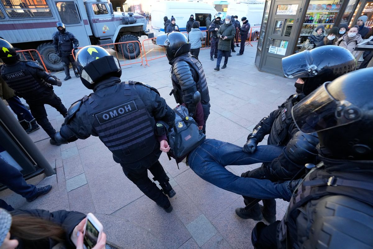 Police detain a demonstrator during an action against Russia
