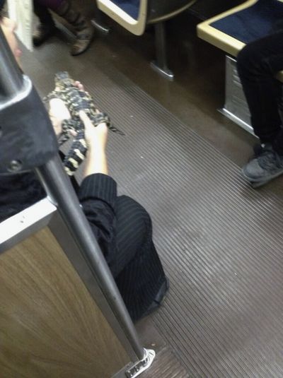 This Nov. 1 photo provided by rider Mark Strotman shows a woman holding a 2-foot-long alligator on a Chicago Transit Authority Blue Line train in Chicago. (Associated Press)