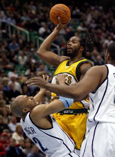 
Seattle's Chris Wilcox, draws a foul on Utah's Derek Fisher. 
 (Associated Press / The Spokesman-Review)