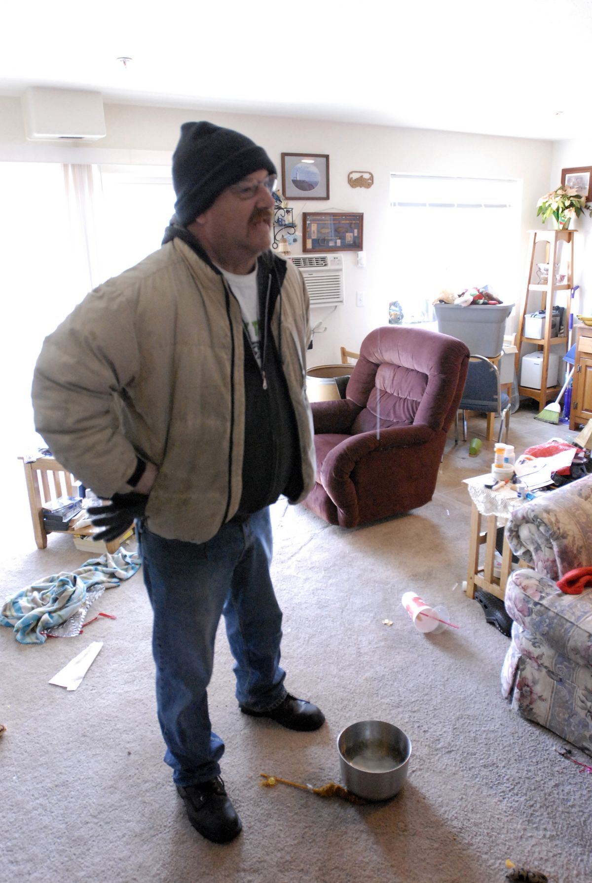 Richard Michaels watches as water drips from the ceiling of his third-floor apartment at the Rosevue Apartments Tuesday. More than a dozen water pipes froze and broke in the building due to inadequate insulation and freezing temperatures, displacing several people from the building. The Spokane Valley Fire Department and the American Red Cross were called to the scene. (J. BART RAYNIAK / The Spokesman-Review)