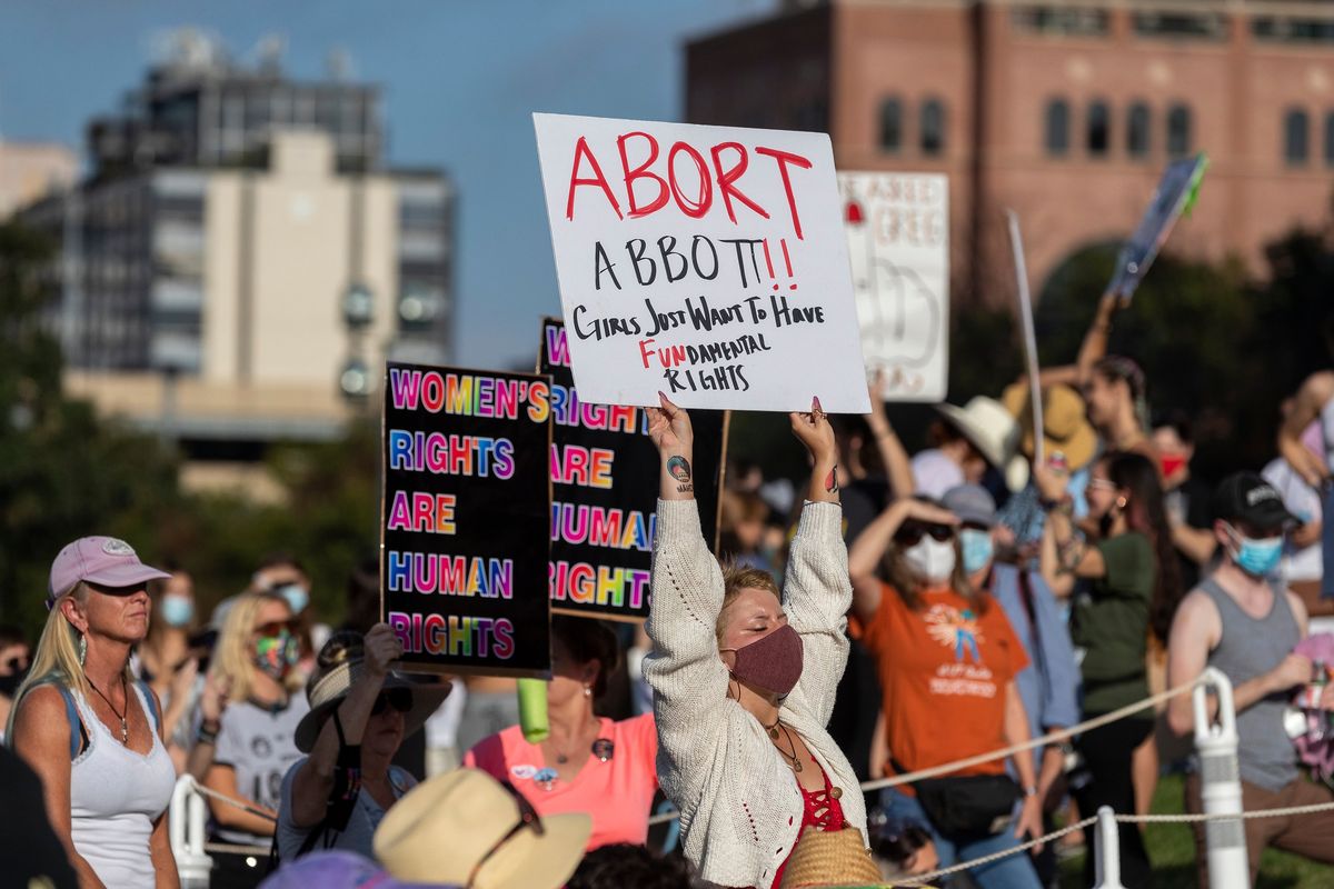 FILE – People attend the Women’s March ATX rally, Saturday, Oct., 2, 2021, at the Texas State Capitol in Austin, Texas. An expected decision by the U.S. Supreme Court in the coming year to severely restrict abortion rights or overturn Roe v. Wade entirely is setting off a renewed round of abortion battles in state legislatures.  (Stephen Spillman)