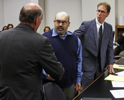 Naveed Haq, center, shakes hands with his attorney after a mistrial was declared in his case June 4, 2008. Haq was accused of entering the Jewish Federation of Greater Seattle and opening fire, killing one woman and wounding five, on July 28, 2006.  (File Associated Press / The Spokesman-Review)