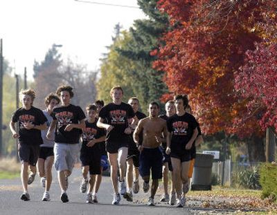 
The West Valley High cross country boys team runs east on Euclid in Spokane Valley during an after-school practice Tuesday. The team will be trying for a state berth at today's regional meet at Deer Park Golf Course.
 (Liz Kishimoto / The Spokesman-Review)