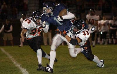 
LC's Brett Bemis can't shake Post Falls' Erik MacDonald (35) and Troy Clark.
 (Tom Davenport/ / The Spokesman-Review)