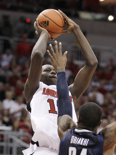 Louisville’s Gorgui Dieng shoots over Connecticut’s Alex Oriakhi. Dieng had 13 points and 12 rebounds in the 71-58 Louisville win. (Associated Press)