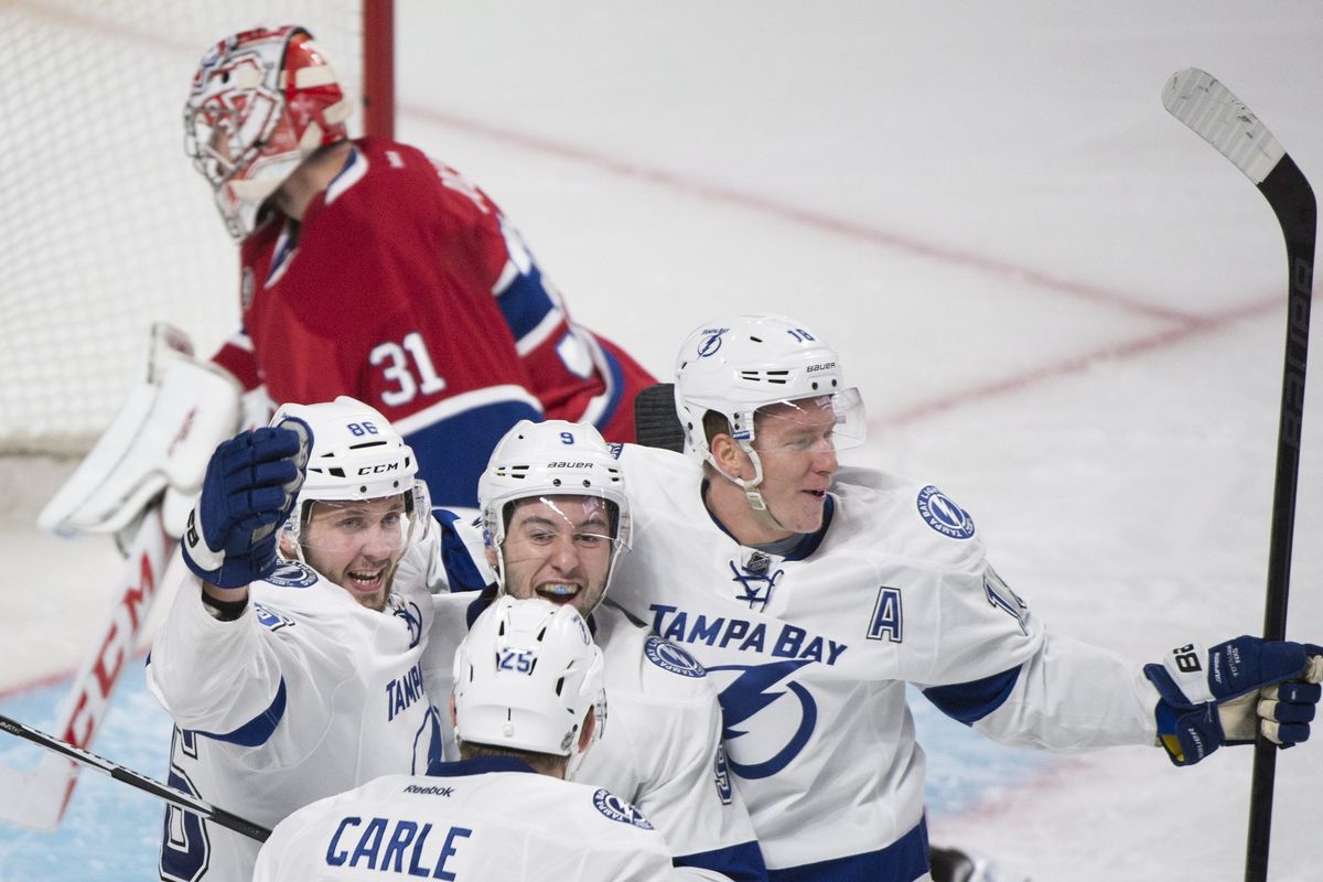 Tyler Johnson is hugged by Lightning teammates after scoring winner with 1.1 seconds left. (Associated Press)
