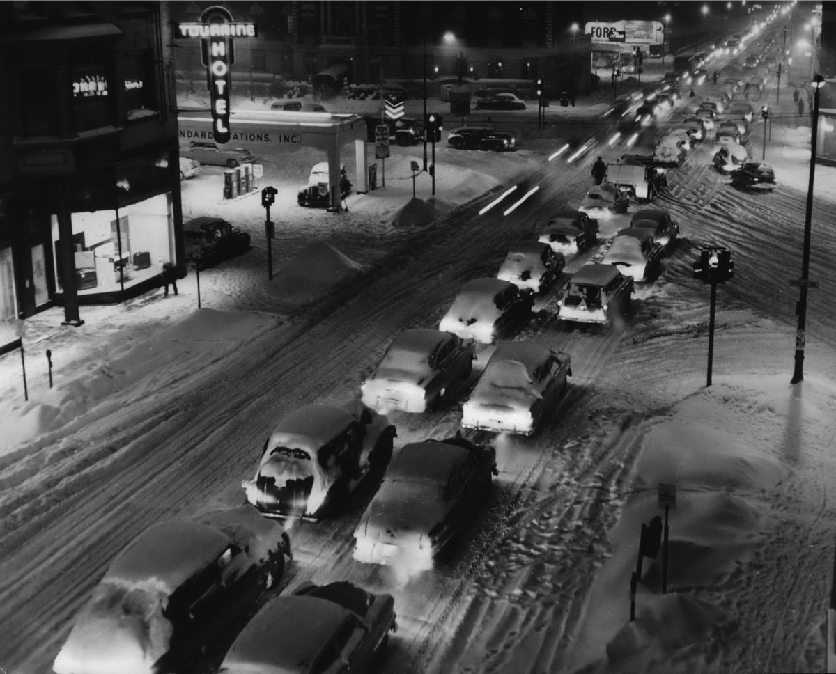 Record Snowfall which began in the afternoon of January 21, 1955, brought traffic tie-ups and the closing of schools in Spokane. The snowfall totaled 12.2 inches. At left is the Touraine Hotel, a longtime residency hotel that housed downtown workers. The was actually three buildings, the Touraine, the Heath Block and the Touraine Annex. All were gone by 1968 and the land used for parking until the Spokesman-Review and Spokane Daily Chronicle production facility was built there in 1980. (PHOTO ARCHIVE / SR)