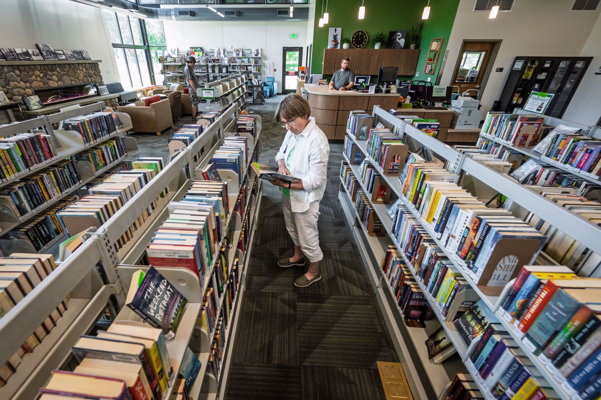 Vicki Nielsen browses books on Wednesday in the newly built Loon Lake Library. The new facility is about six times larger than the previous building and includes a community resource meeting space and computers to access the internet, which is hard to come by in many rural Stevens County areas. (COLIN MULVANY /THE SPOKESMAN-REVIEW)
