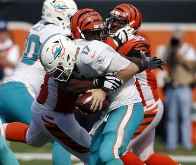In this Oct. 7, 2018, file photo, Cincinnati Bengals defensive tackle Geno Atkins sacks Miami Dolphins quarterback Ryan Tannehill (17) during the second half of an NFL football game, in Cincinnati. Atkins sacked Ryan Tannehill twice and hit him three other times as he was getting rid of the ball. The Bengals defensive tackle simply pushed through the Miami Dolphins’ line, his latest disruptive performance in an impressive start to the season. (Frank Victores / Associated Press)