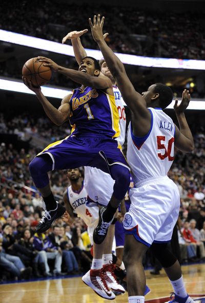 Lakers’ reserve point guard Darius Morris (1) drives past Sixers’ Lavoy Allen on the way to a career-high 15 points. (Associated Press)