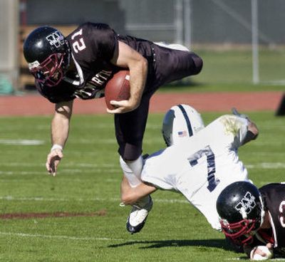 
Menlo's Chris Dombey catches Whitworth running back Kyle Havercroft in a one-arm tackle during the first quarter in the Pine Bowl on Saturday. 
 (Dan Pelle / The Spokesman-Review)
