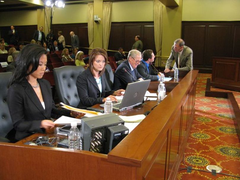 Panelists and moderator Thanh Tan, left, of Idaho Public Television, prepare for the first 