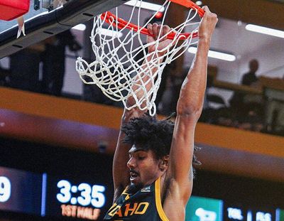 Idaho forward Julius Mims hangs on the rim after dunking the ball against Evergreen State during a nonconference game Tuesday in Moscow, Idaho.  (Courtesy of Idaho Athletics)