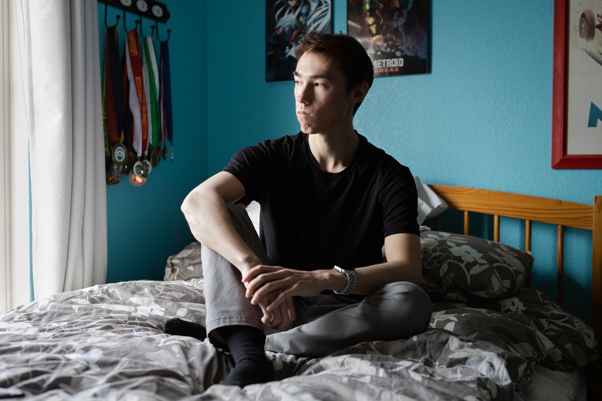 Lucas Chung, who is applying to dozens of jobs a week and living with his family after graduating from college in May, poses in his room at his parent’s home in Windsor, Calif.  (Constanza Hevia H./For the Washington Post)