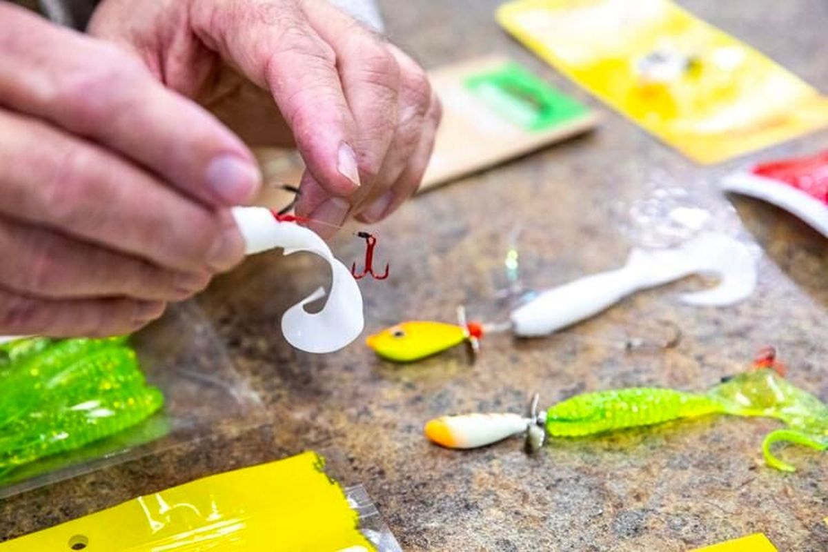 John Snaza handles lures used for catching walleye at North 40 Outfitters in Lewiston.  (August Frank/Lewiston Tribune)