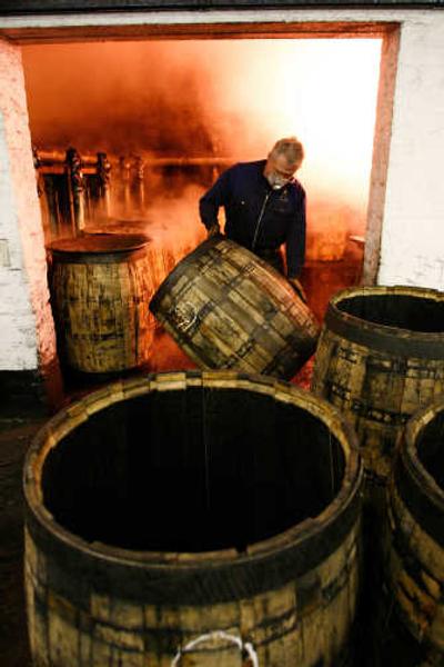 
A cooper moves a rebuilt oak cask at Diageo PLC's traditional cooperage at Carsebridge, Scotland, last month. Associated Press
 (Associated Press / The Spokesman-Review)