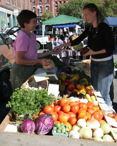 Recent studies show that shoppers at farmers markets like this one in Massachusetts engage in 10 times as many conversations as shoppers in large retail stores. People who shop locally tend to be community builders and rate themselves as 