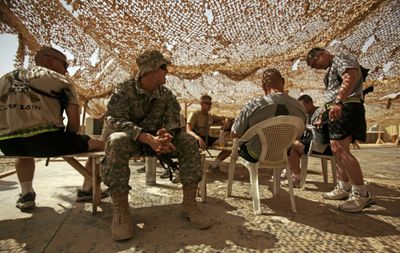 U.S. Army soldiers from C Co., 1st Battalion, 5th Infantry Regiment are seen resting in the shade at Forward Operating Base Warhorse in Baqouba, Iraq, on Tuesday.  (Associated Press / The Spokesman-Review)