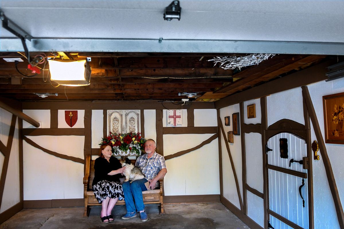 William and Susie DeLine sit with their dog Benny in their Tudor-style remodeled garage in Spokane. The couple grew a fondness for Tudor style after living in England for a time.  (Kathy Plonka/The Spokesman-Review)