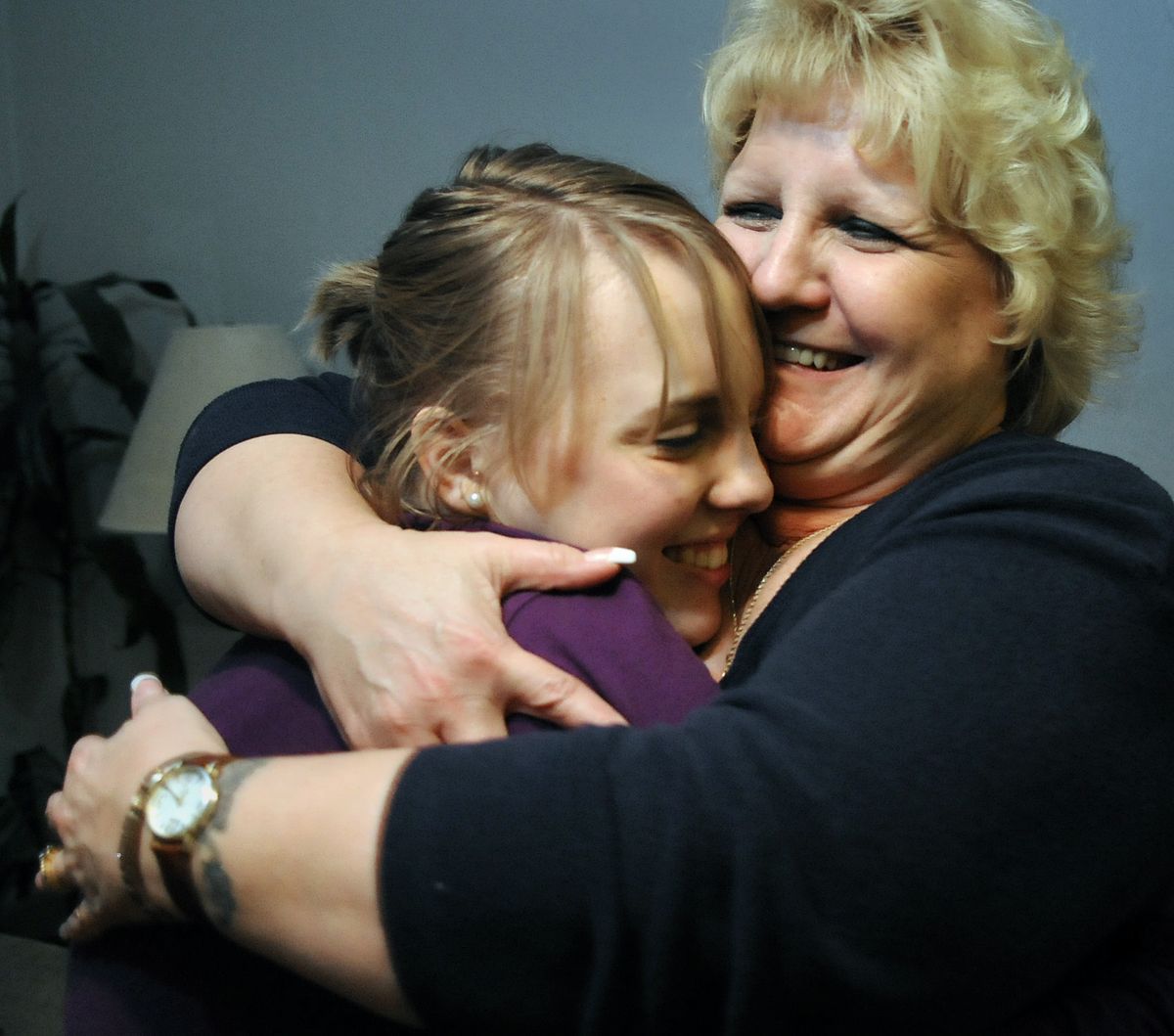 Carissa Outen embraces her mother, Gwen Ashcraft, at the family home in northwest Spokane. (Dan Pelle)