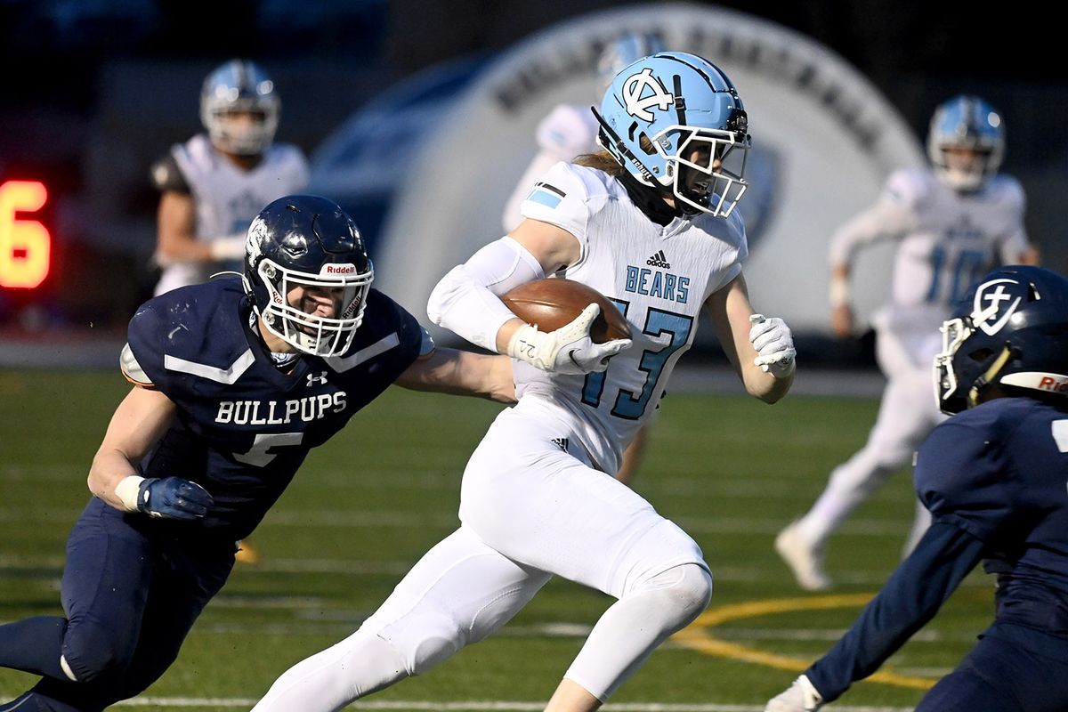 Central Valley wide receiver Brandon Bruegeman (13) gains first-down yardage as Gonzaga Prep linebacker Daniel McKeirnan (5) gives chase during the first half of a GSL football game, Friday, April 9, 2021, at Gonzaga Prep.  (COLIN MULVANY/THE SPOKESMAN-REVIEW)