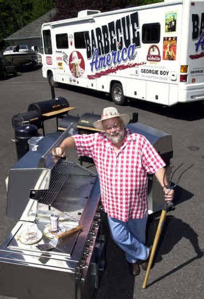 
Barbecue specialist Rick Browne poses with some of his barbecue gear in front of his 35-foot Georgie Boy motor home, in Ridgefield, Wash. 
 (Associated Press / The Spokesman-Review)